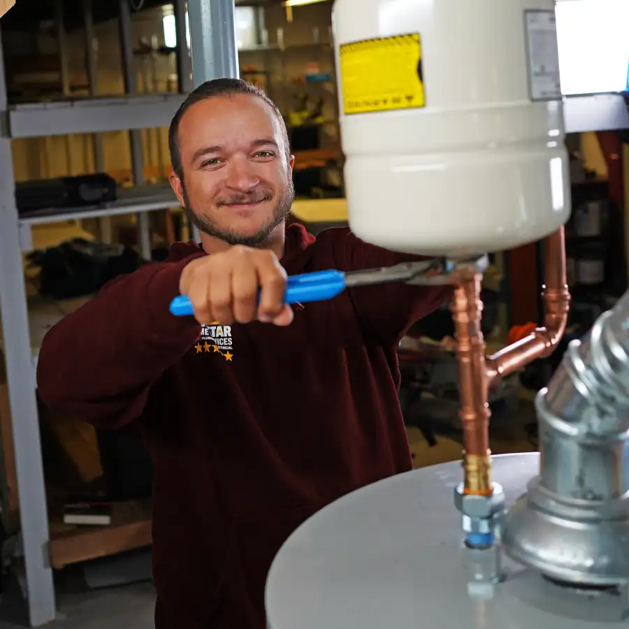 Plumber fixing a gas line on a water heater