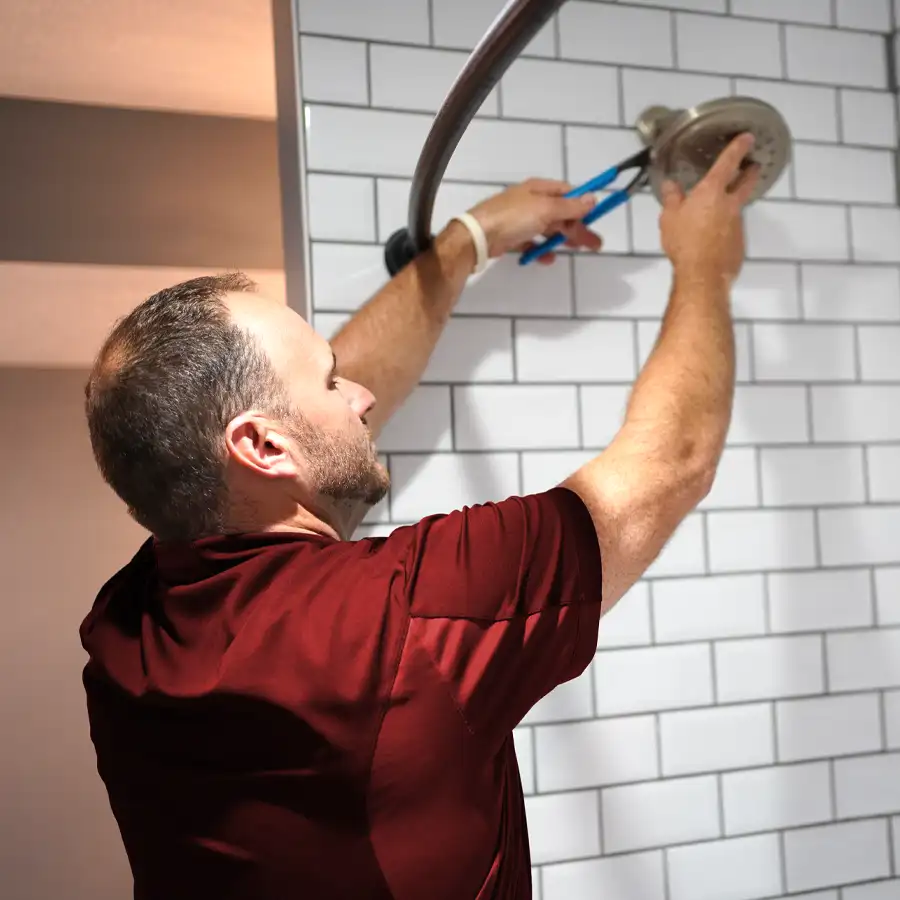 Plumber fixing a shower head