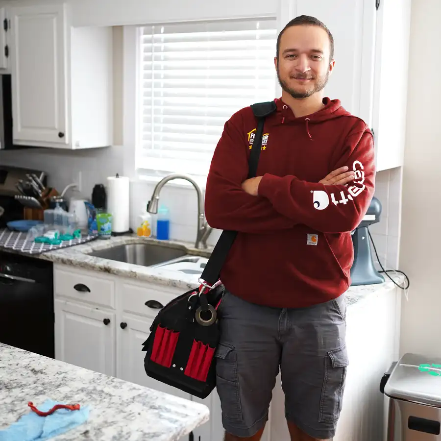 Plumber in front of a kitchen sink